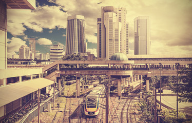 Naklejka na ściany i meble Retro stylized photo of a modern city, Kuala Lumpur, Malaysia,.