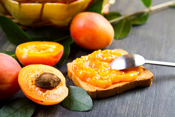 Apricots with leaves on the old wooden table