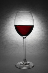 Beautiful glass of red wine on grey