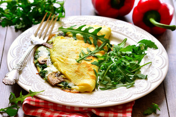 Omelet stuffed with spinach and mushrooms.