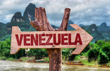Venezuela wooden sign with countryside background