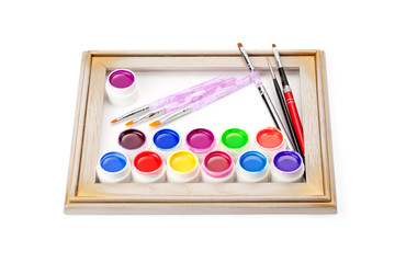 paints and brushes in the frame of