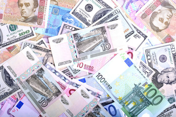 Obraz na płótnie Canvas Heap from dollars, the ukrainian money and euro