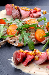 Appetizer with mushrooms, meat and tomatoes