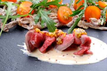 Appetizer with mushrooms, meat and tomatoes