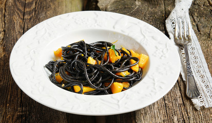 black spaghetti with pumpkin and garlic sauce