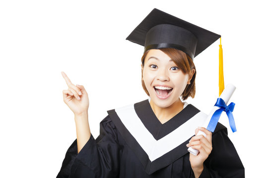 happy young woman graduating holding diploma and pointing