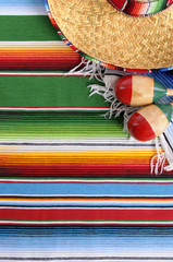 Mexican background serape striped blanket with sombrero maracas Mexico cinco de mayo festival vacation photo vertical © david_franklin