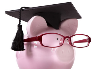 Student Piggy Bank or piggybank wearing graduate cap and glasses isolated on white background photo