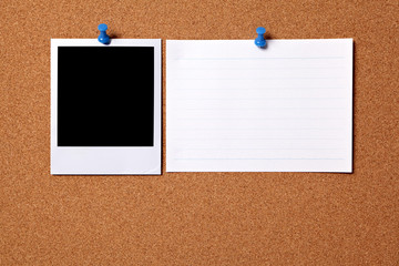 One single polaroid style photo frame print pinned to a cork notice board background next to office index file card