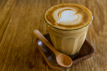 Cappuccino or latte coffee on wooden table.