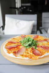 Pizza margherita with parma ham and rocket