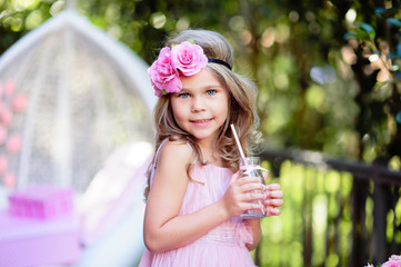 Little girl celebrate Happy Birthday Party with rose outdoor