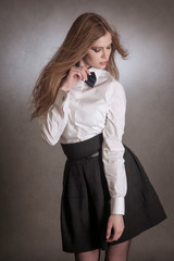 Blondie woman in white shirt and black bow-tie