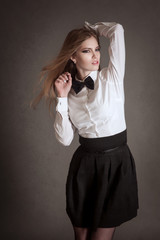 Fototapeta premium Blondie woman in white shirt and black bow-tie