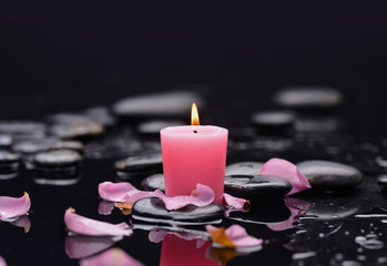 pink rose petals with pink candle and therapy stones 