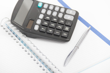 Business concept with calculator, pen and notebook