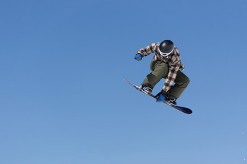 Snowboarder jumps in Snow Park