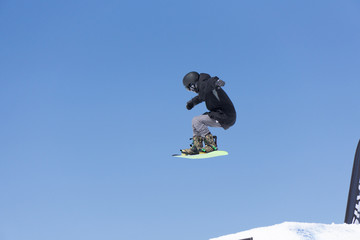 Snowboarder jumps in Snow Park