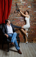 man in a chair and the woman in shackles in the room