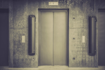 Metal elevator doors in a minimalistic style interior lobby