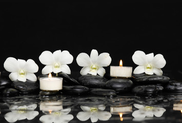 Fototapeta na wymiar Three White orchid with candle and therapy stones