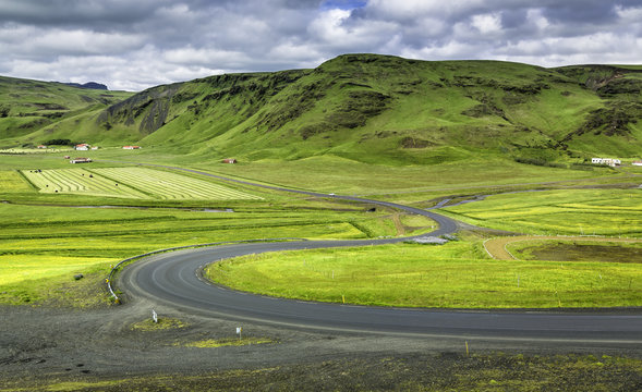 Icelandic mountain landscapes with curved asphalt road