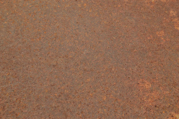 The texture of rusty metal. Abstract background, horizontal frame. Rough brown surface.