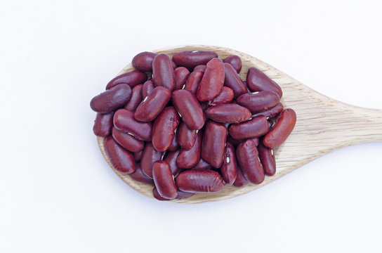 Red beans on wooden spoon isolated on white
