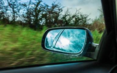 car on the road and rear view mirror