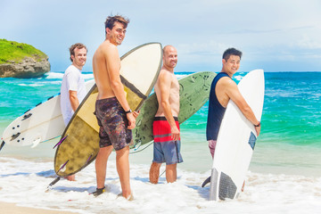 group of surfers on a beach