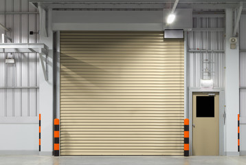 Obraz na płótnie Canvas Roller door or roller shutter. Also called security door or security shutter with automatic system. For protection industrial building i.e. factory, warehouse, hangar, workshop, store, hall or garage.