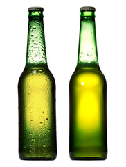 Green bottle of beer with drops on white background