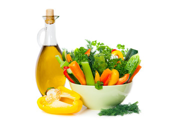 The dish of ripe vegetables and glass jar with olive oil