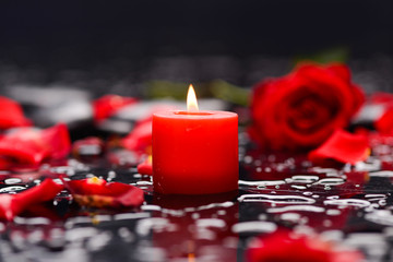 Beautiful red rose,petals with candle and therapy stones