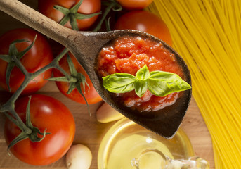 wooden ladle with tomato sauce