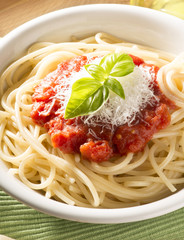 dish with spaghetti and its ingredients on the wooden table