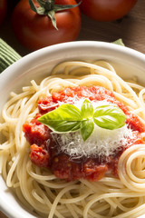dish with spaghetti and its ingredients on the wooden table