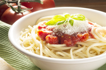 dish with spaghetti and its ingredients on the wooden table