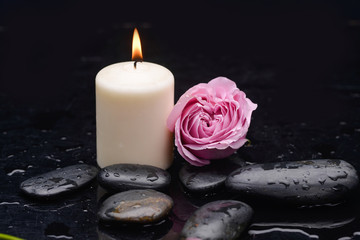 pink rose with candle and therapy stones