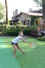 little girl, a teenager playing with a tennis racket