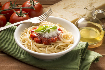 dish with spaghetti and its ingredients on the wooden table
