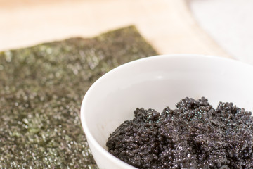 Fresh black caviar in a bowl to make sushi and fish dishes