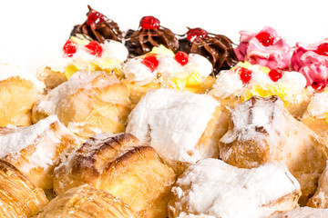 Various desserts with cream topping, coconut and powdered sugar