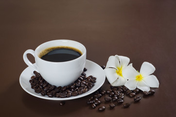 a cup of coffee with 2 flowers