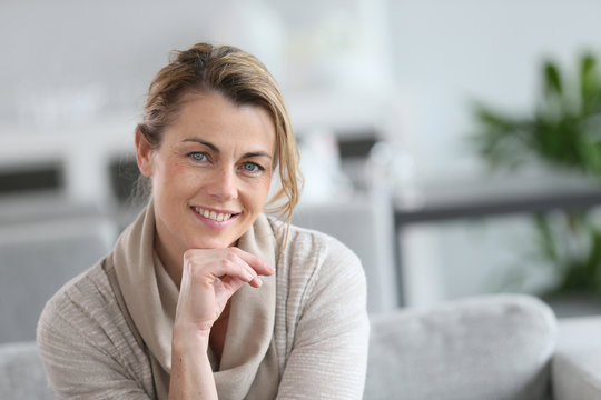 Portrait Of Smiling Mature Woman With Hand On Chin