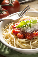 dish with spaghetti and its ingredients on the wooden table