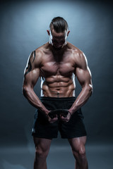 Fototapeta na wymiar Topless Muscular Man Bending an Exercise Bar