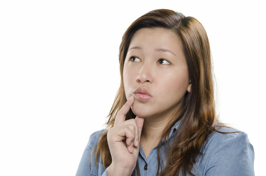 Young woman thinking against white background