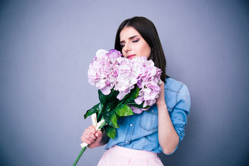 Young beautiful woman smelling flowers